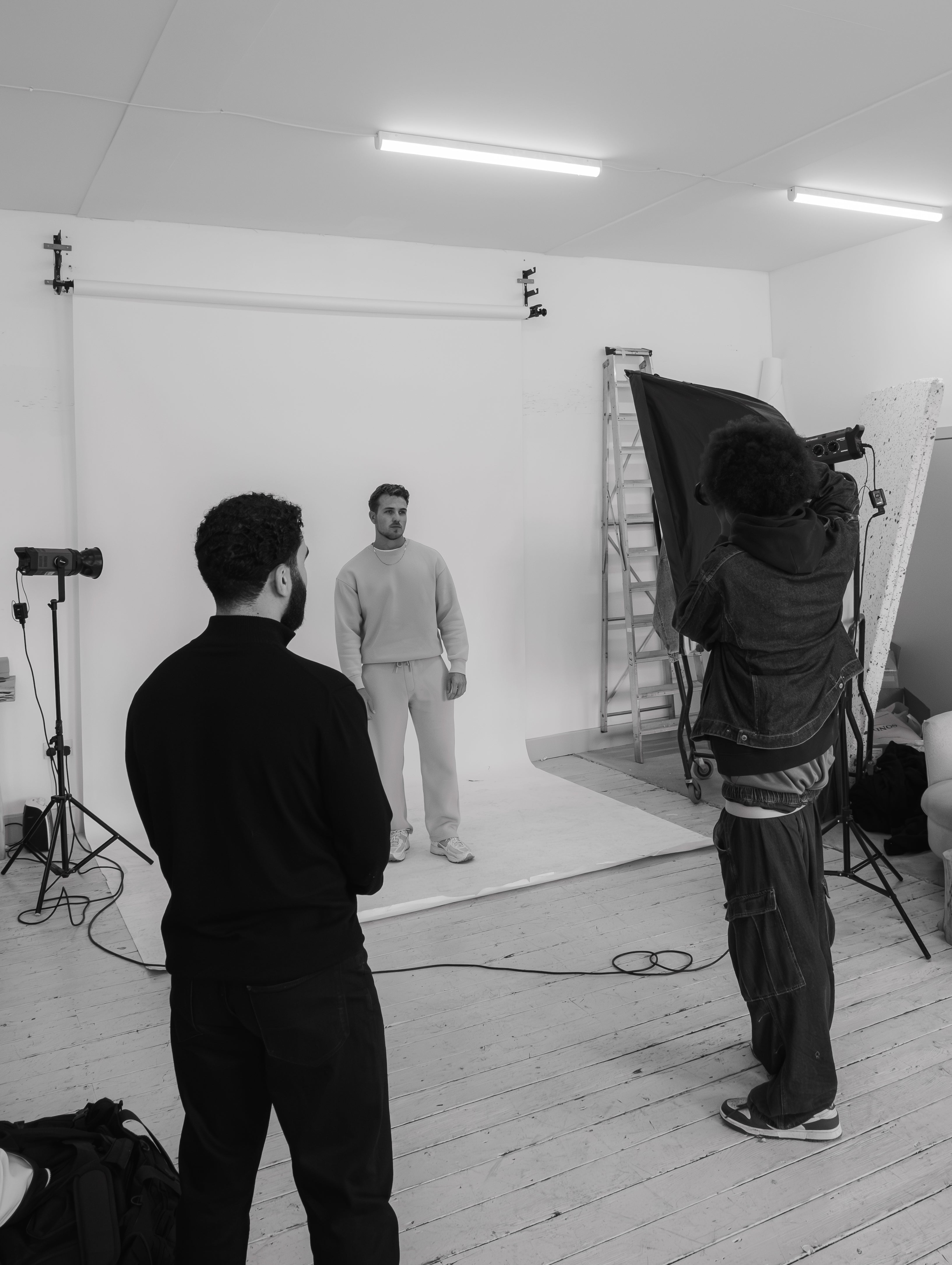 Studio setting with a person in the center, surrounded by photography equipment at a Sonder Community Photoshoot.
