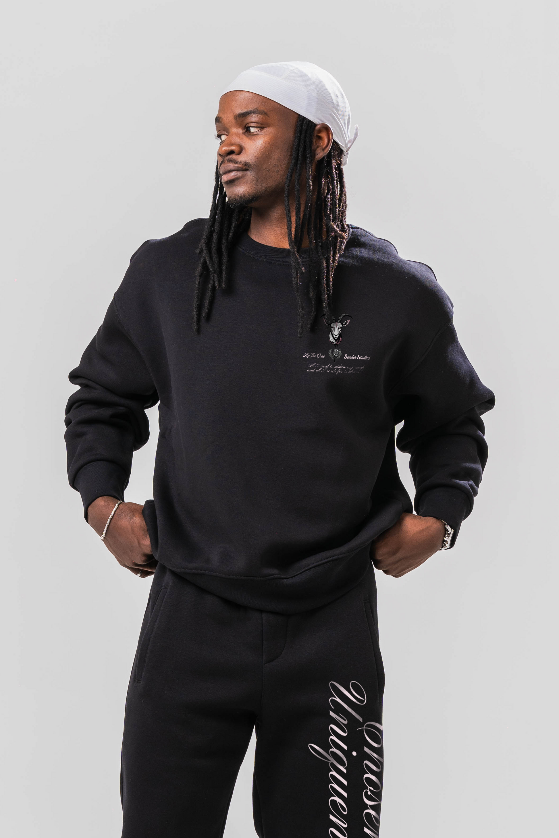 Male model wearing the Sonder Black Oversized sweatshirt with the oversized joggers. Standing in front of a light grey background.