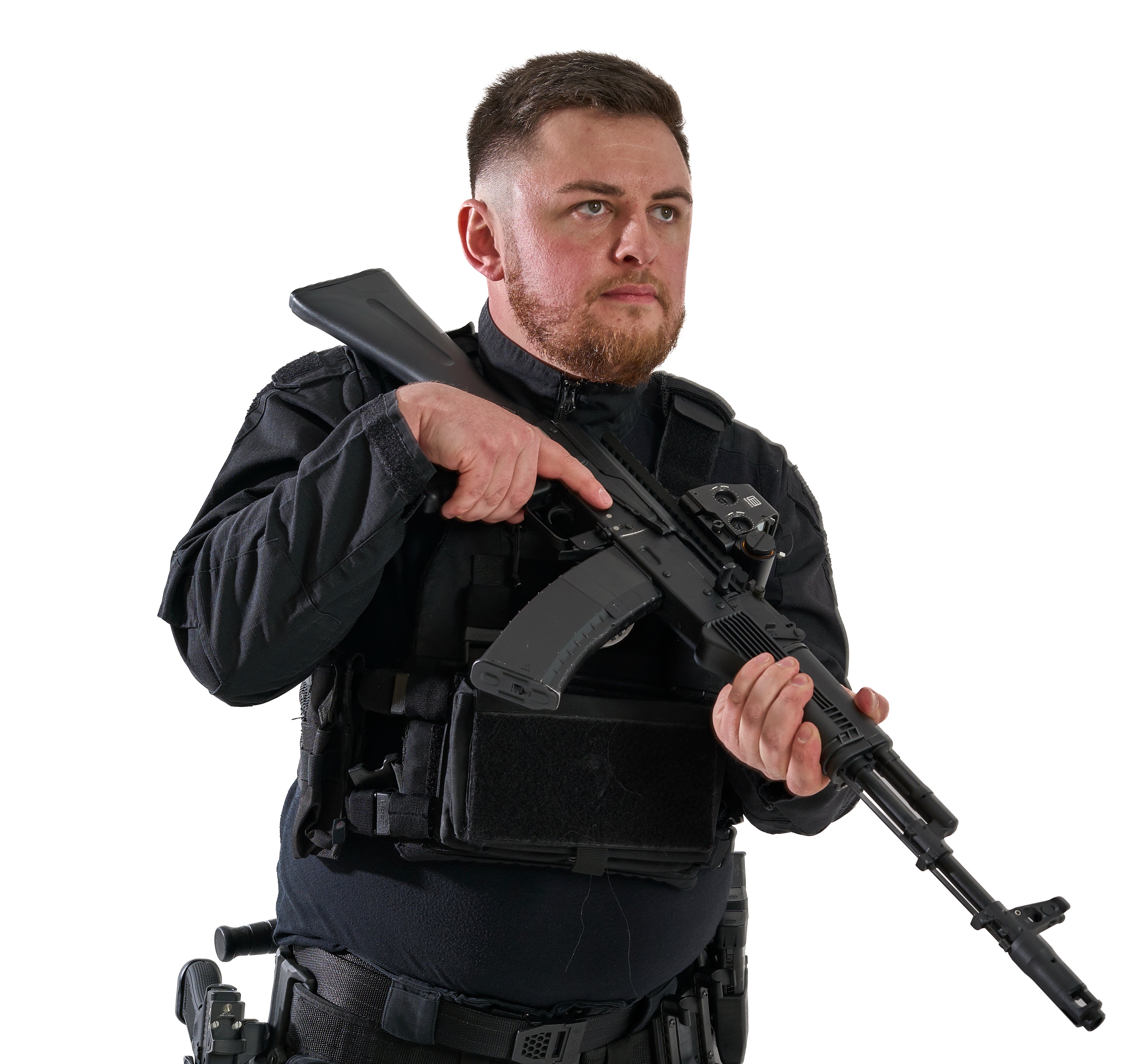 Man in tactical gear holding a rifle on a white background